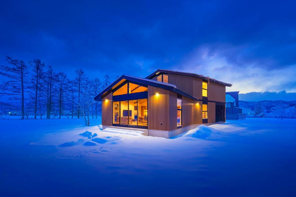 a small house in the snow at night at Sakuraya in Hakuba