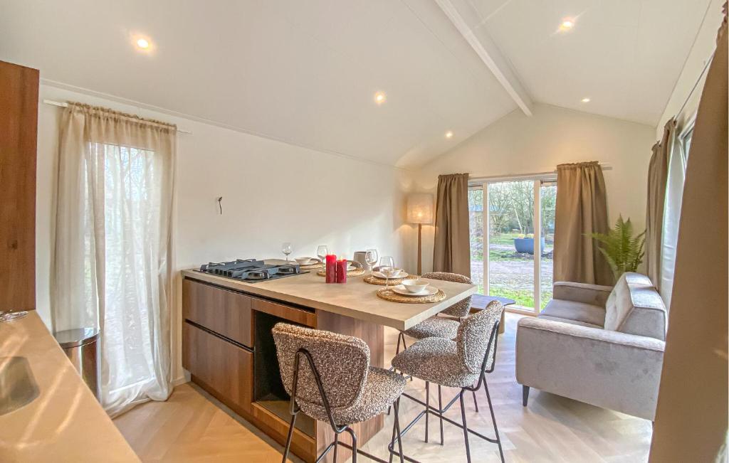 a kitchen with a table and chairs in a room at Sernets Recreatie Chalet 112 in Oud-Gastel