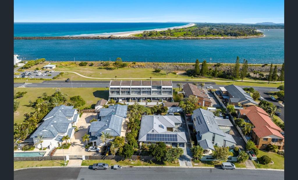 an aerial view of a large building next to the ocean at Beach Side Getaway Lighthouse Beach in East Ballina