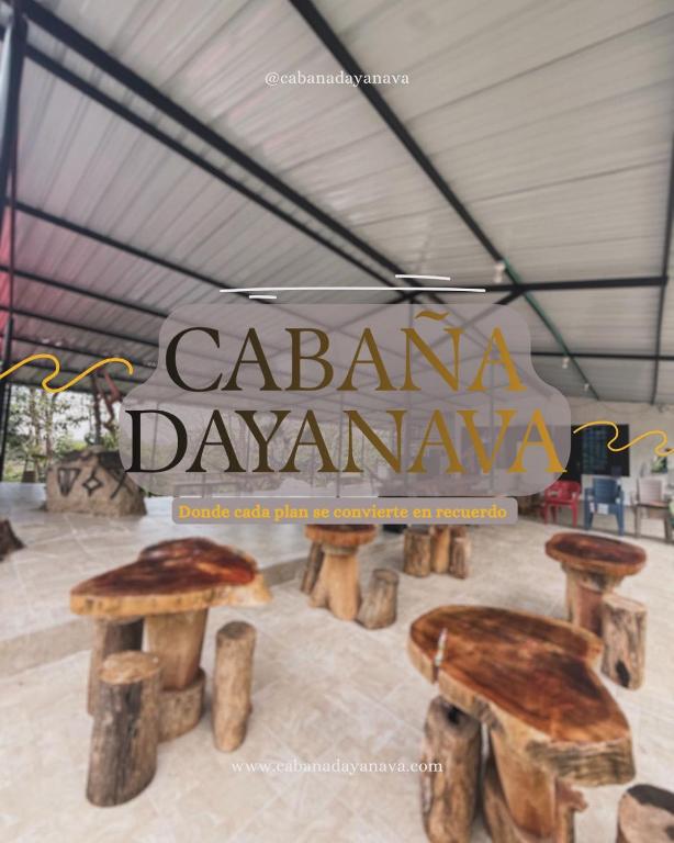 a sign that says cabana dawnana with two wooden benches at Cabaña DAYANAVA in Aguazul