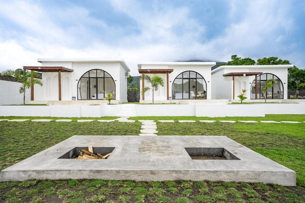 a house with a fire pit in front of it at Lazura Serenite in Bangli
