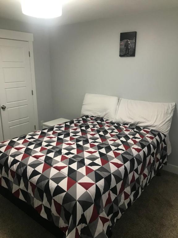 a bedroom with a black and white checkered bed at Utah Housing in South Jordan