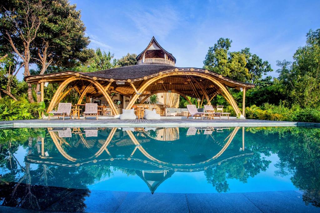 a poolside pavilion with chairs and a swimming pool at Les Terrasses Ceningan in Nusa Lembongan