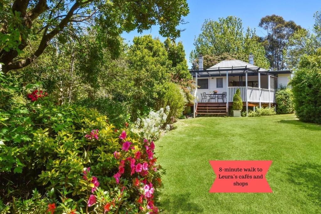a house with a sign in front of a yard at Little Pomander in Leura
