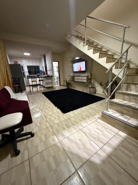 a living room with a spiral staircase and a living room at Casa temporada Capuba in Serra