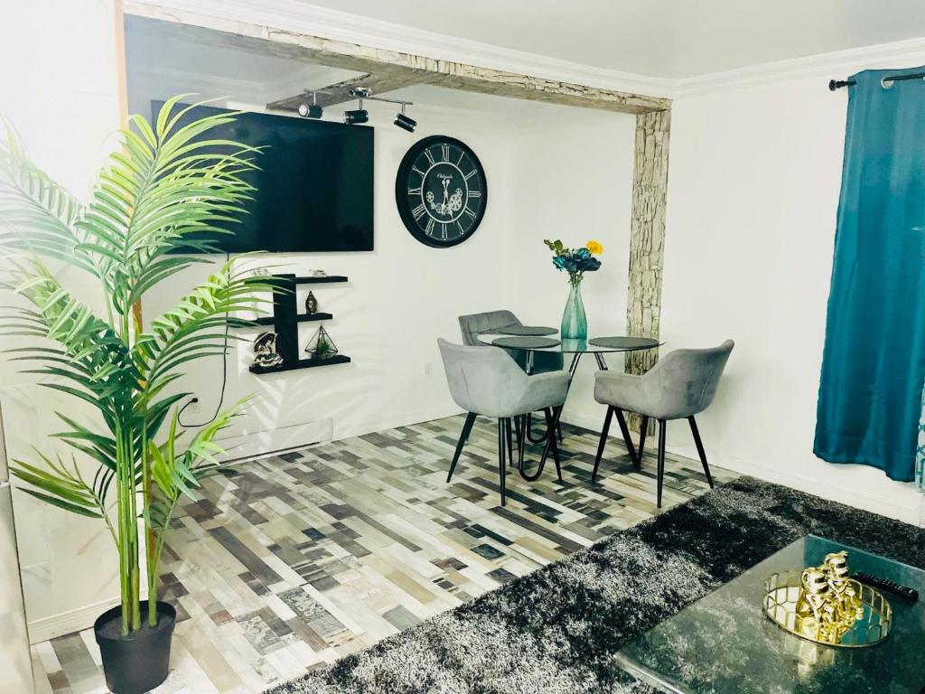 a dining room with a table and a clock on the wall at Linda inn - Entire Unit- Sleep 3- Sherbrooke in Sherbrooke