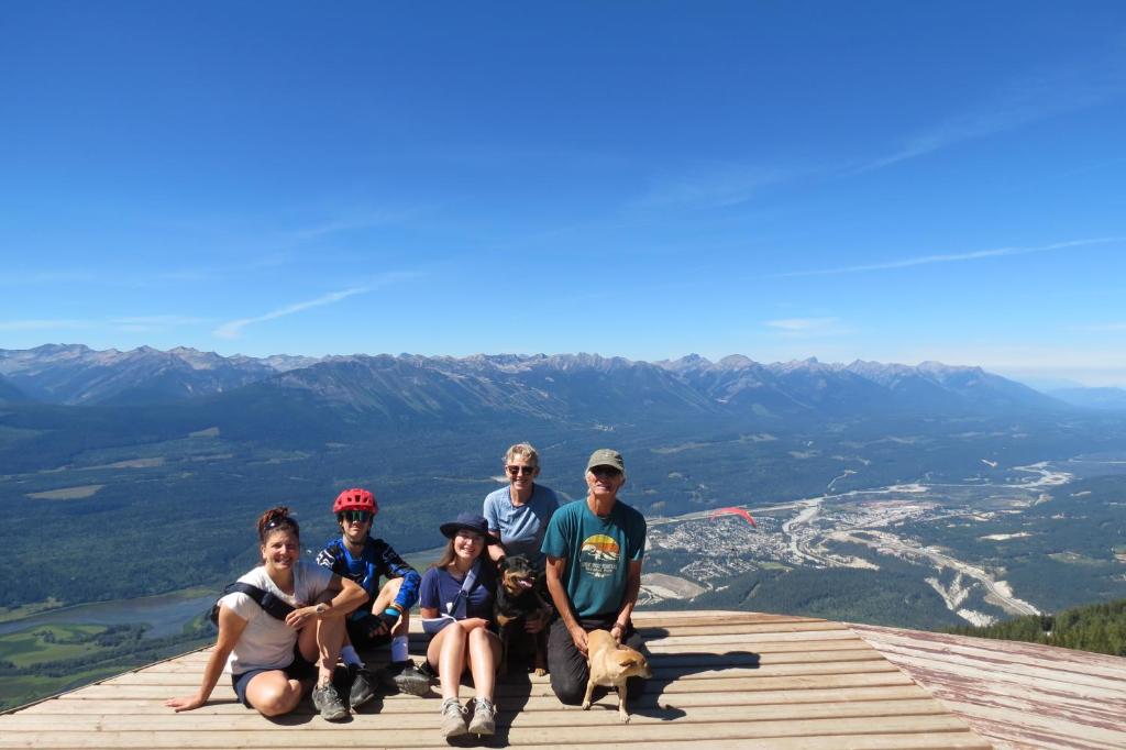 a group of people and a dog on top of a mountain at Friendly Footprint in Golden