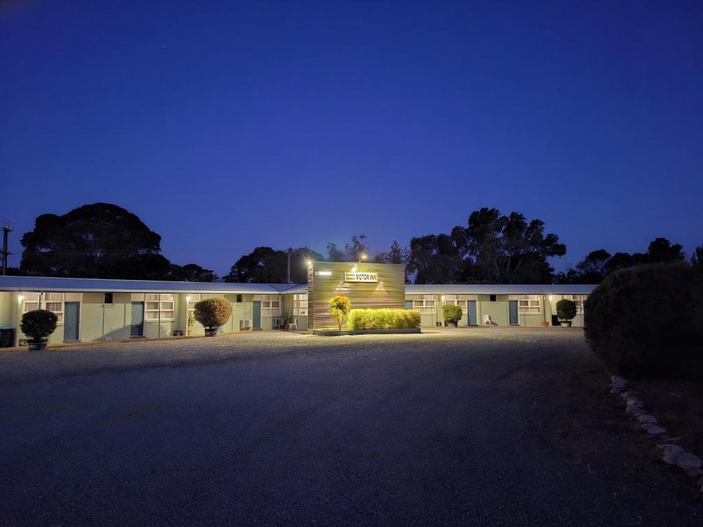 a building with a lit up sign on the side of it at Murray Bridge Motor Inn in Murray Bridge