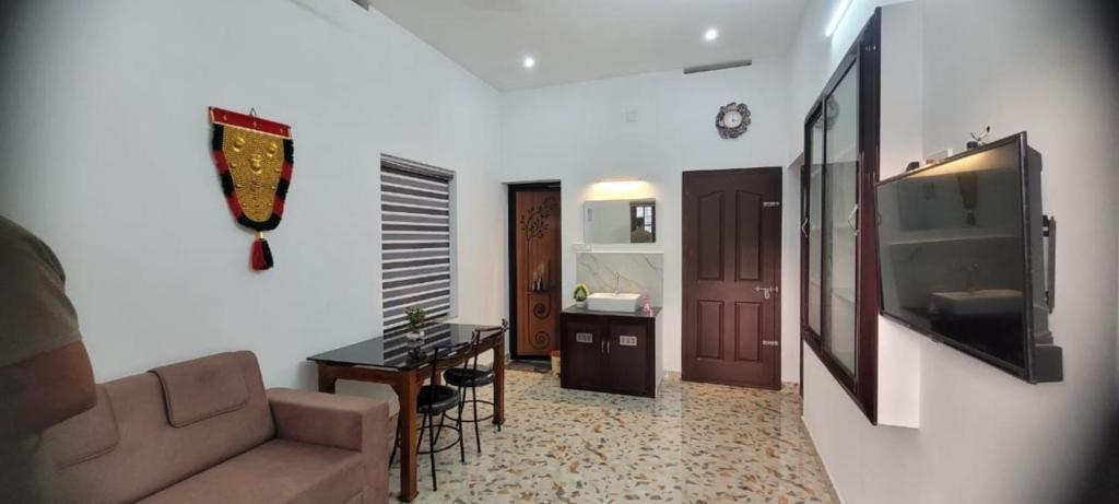 a living room with a couch and a table at Krishna stays in Manattala