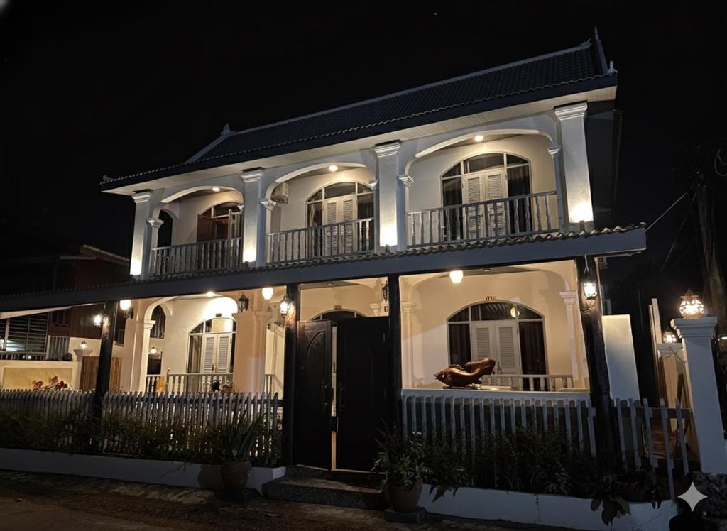 a large white building with lights on it at night at The TARA PRABANG - Luangprabang in Luang Prabang
