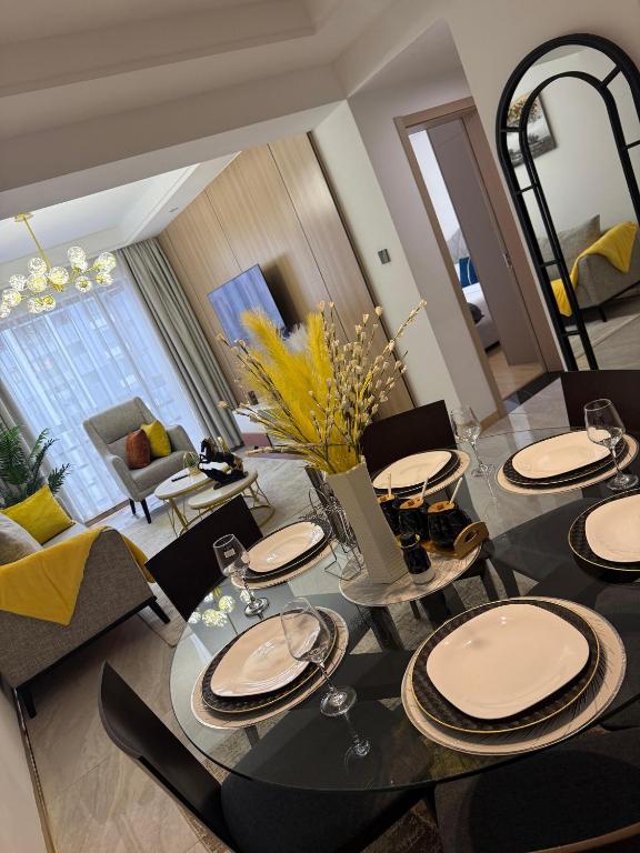 a dining room with a table with chairs and a mirror at Zen Haven Lavington in Nairobi