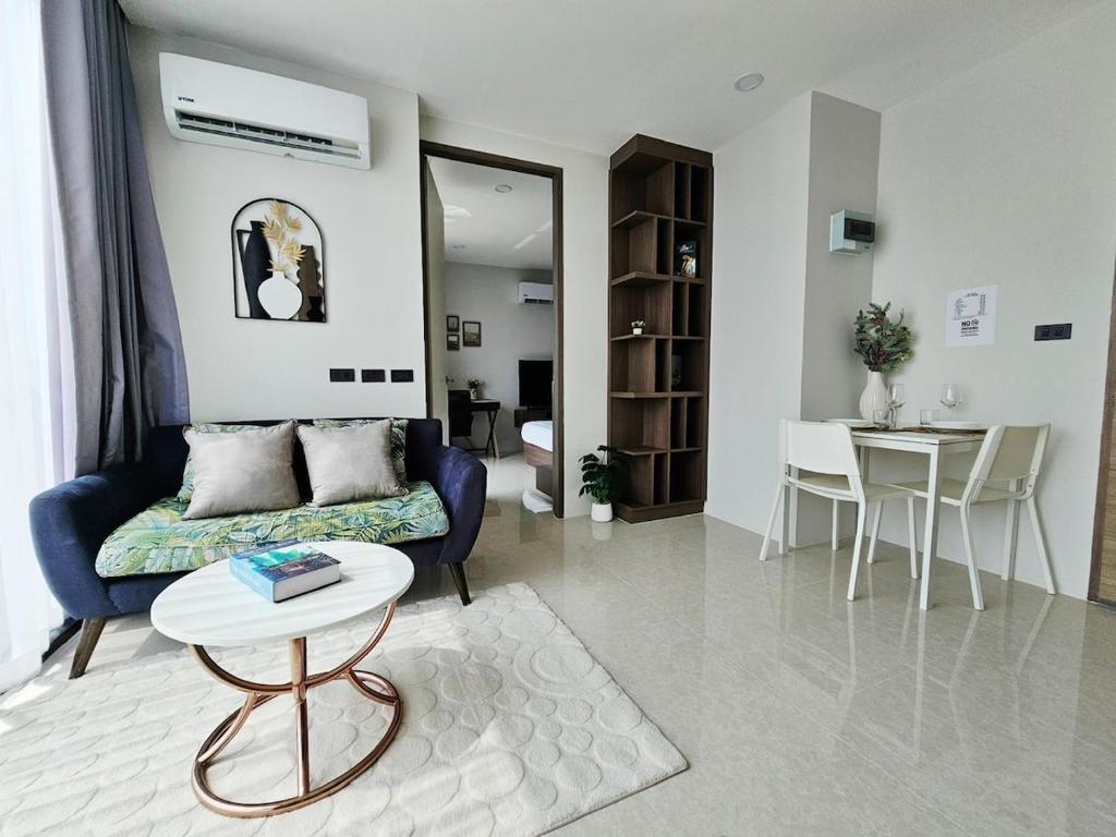 a living room with a couch and a table at patong see view condo in Patong Beach