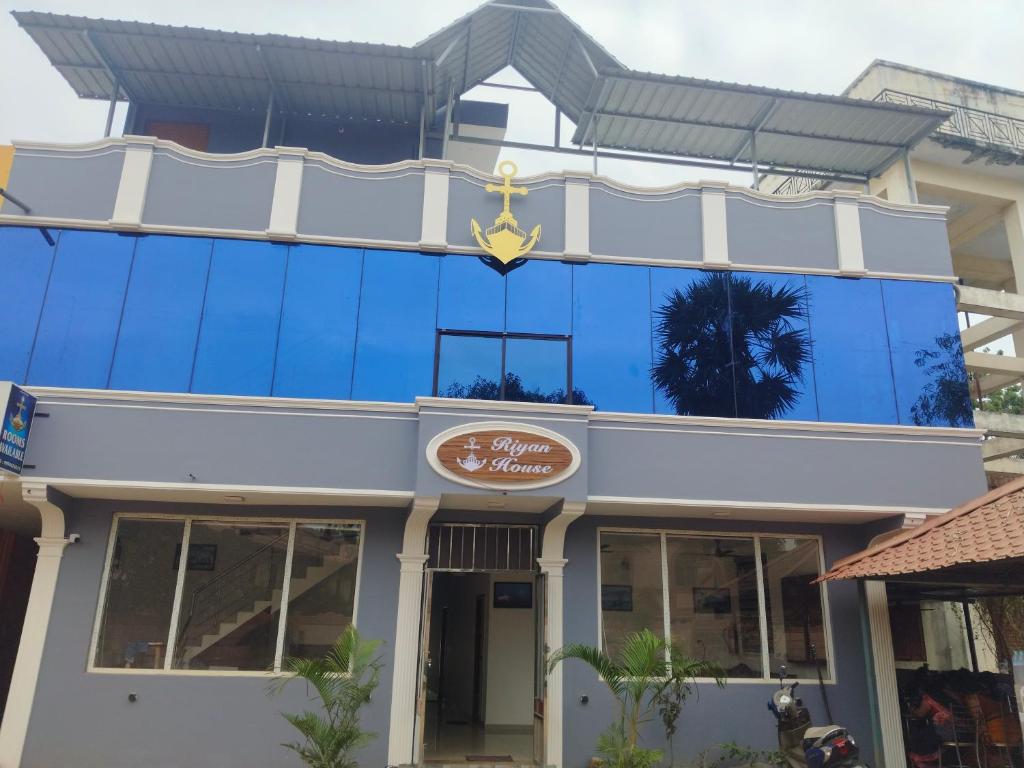 a building with a sign on the side of it at Riyanhouse in Pūrnānkuppam