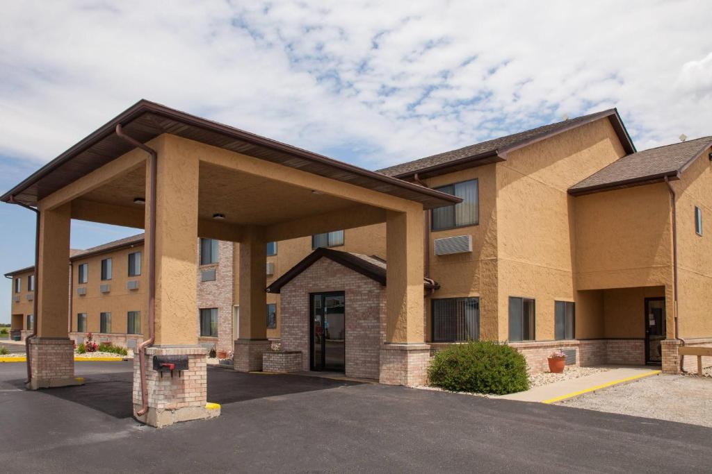 a large building with a parking lot in front at Super 8 by Wyndham Dwight in Dwight