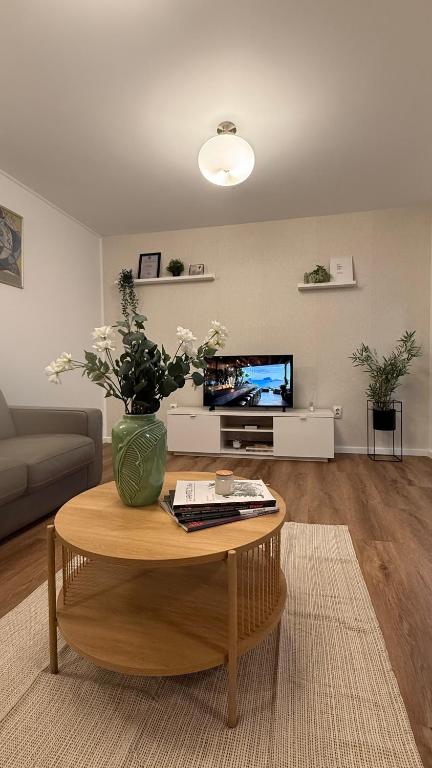 a living room with a vase of flowers on a table at Tudor's apartment in Bucharest