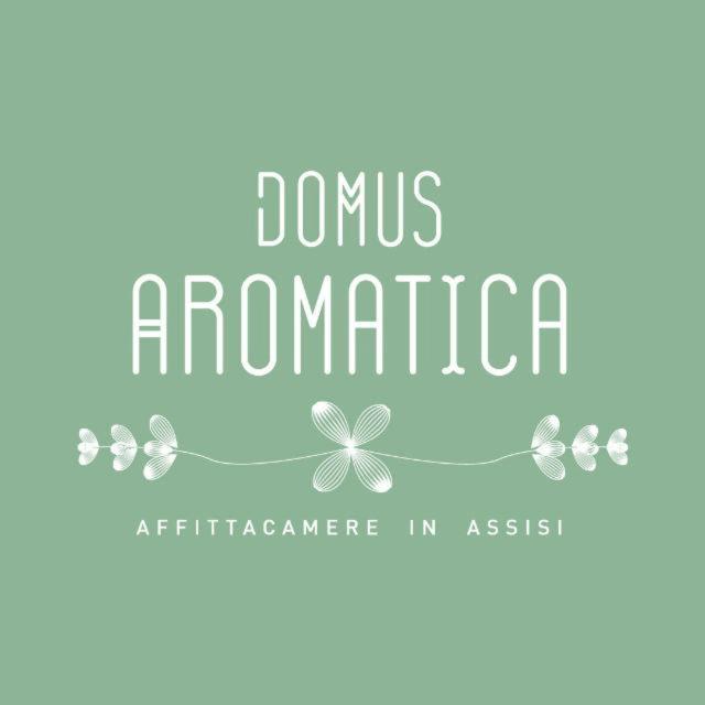 a sign that reads domus aromarine with four butterflies at Domus Aromatica in Assisi