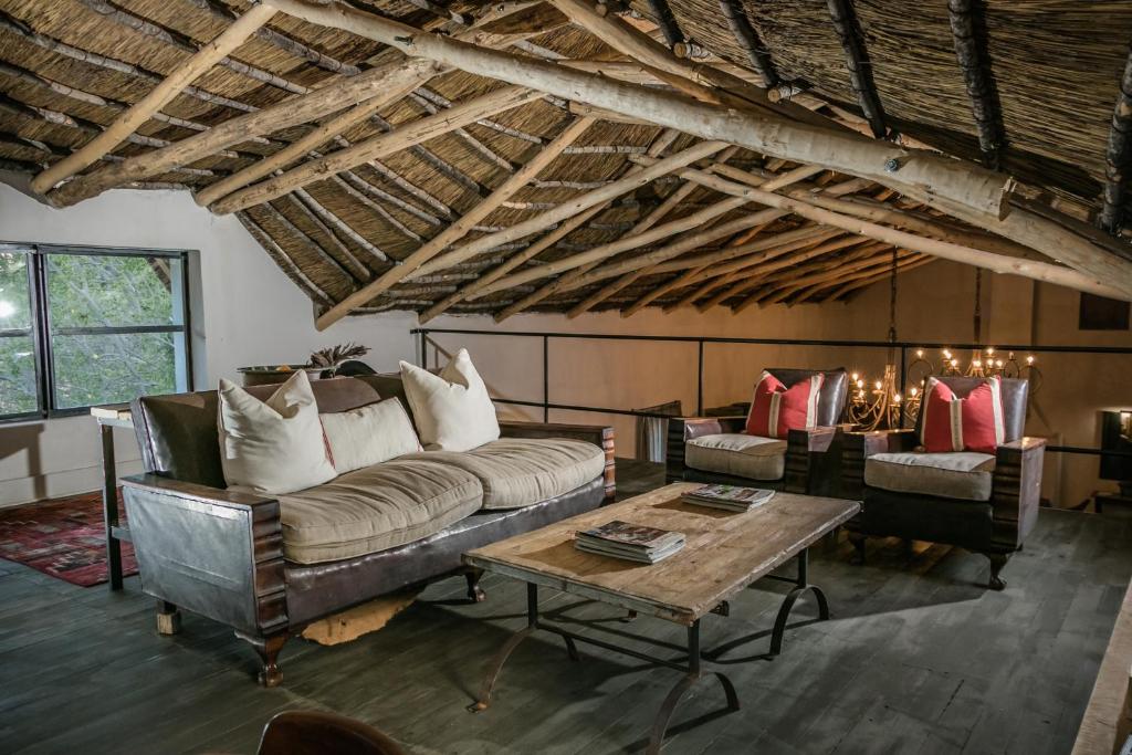 a living room with a couch and a table at The Whyte House in Graaff-Reinet