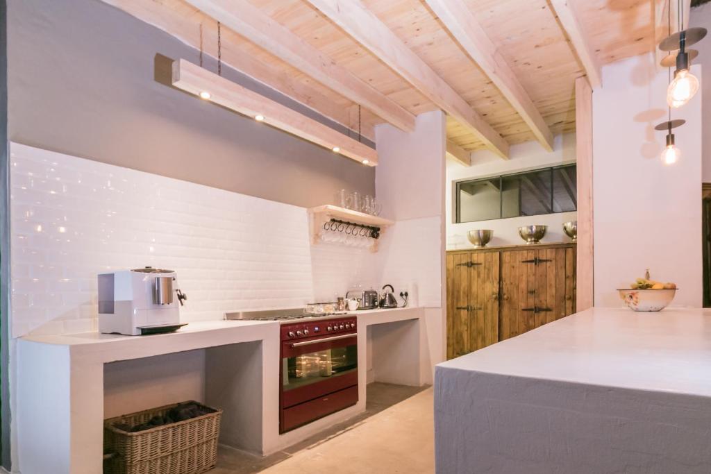 a kitchen with white counters and a stove top oven at The Whyte House in Graaff-Reinet