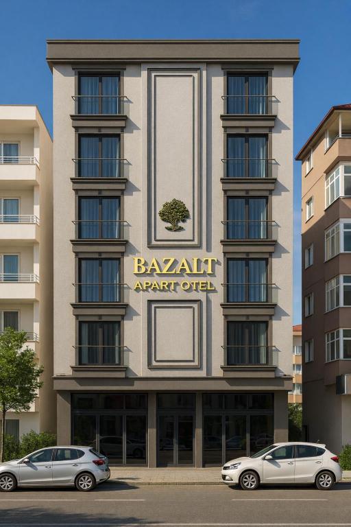 two cars parked in front of a building at Bazalt Apart Hotel in Trabzon