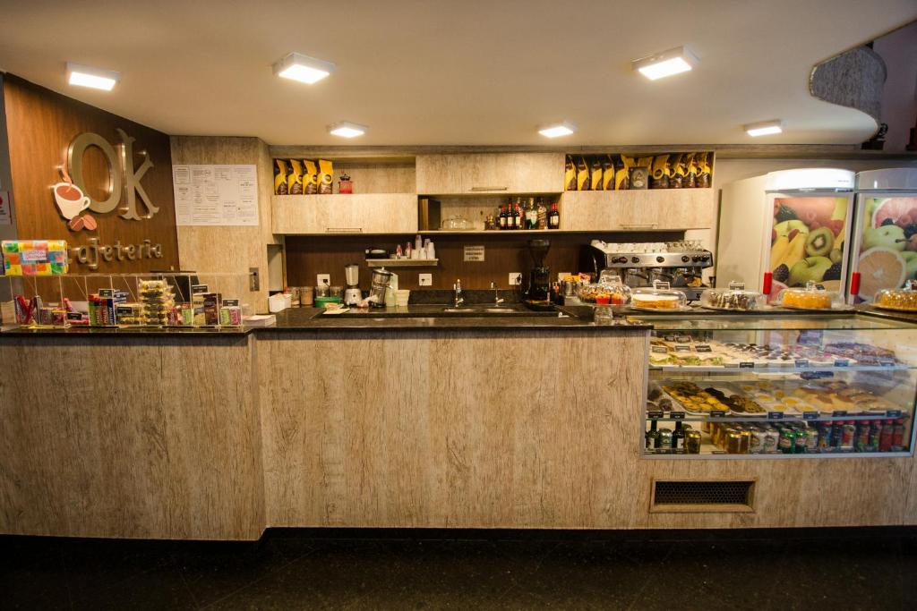 a restaurant with a counter and a bakery at Hotel OK in Rio de Janeiro