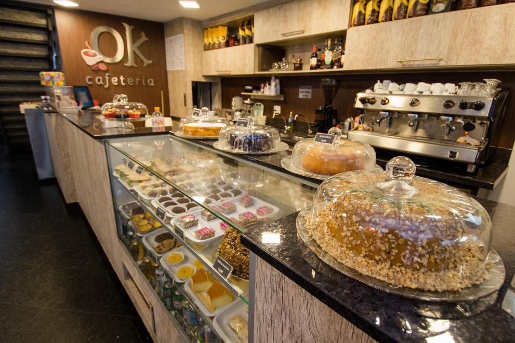 a bakery with a display case filled with pastries at Hotel OK in Rio de Janeiro