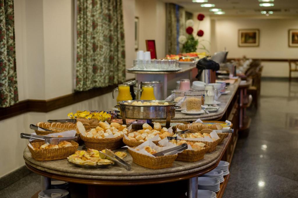 a buffet of food on a table in a room at Hotel OK in Rio de Janeiro