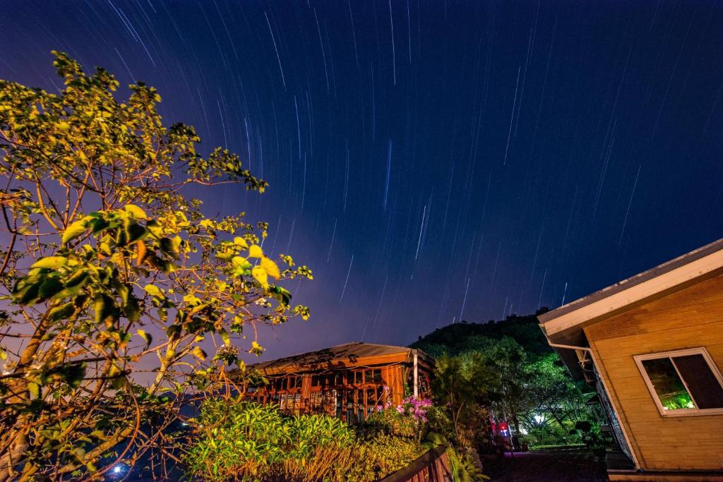 a house with star trails in the sky at night at Natural Residence B&amp;B in Tai&#39;an
