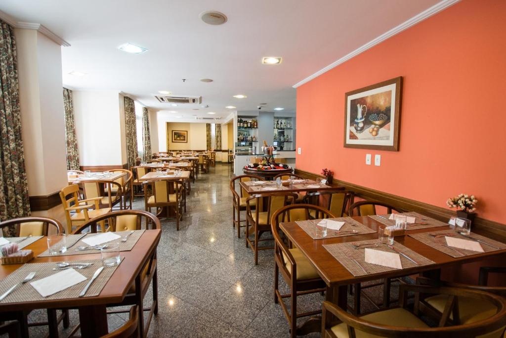 a dining room with wooden tables and chairs at Hotel OK in Rio de Janeiro