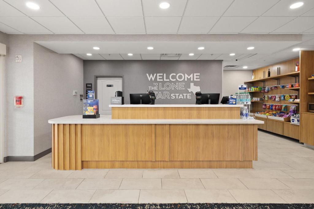 a lobby with a welcome desk in a store at Hampton Inn & Suites McAllen in McAllen