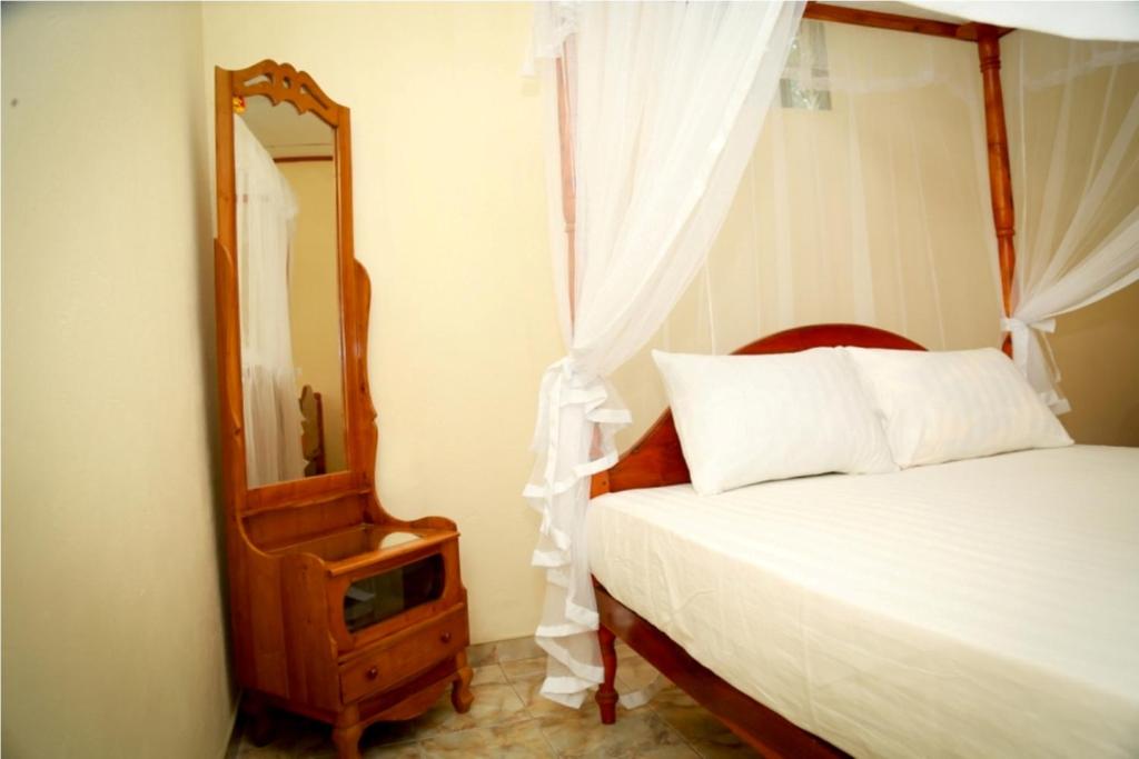 Postel nebo postele na pokoji v ubytování Jaya Home Stay