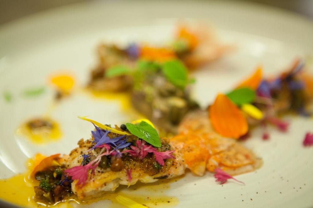 a white plate with some food on it at Logis Auberge le centre poitou in Coulombiers