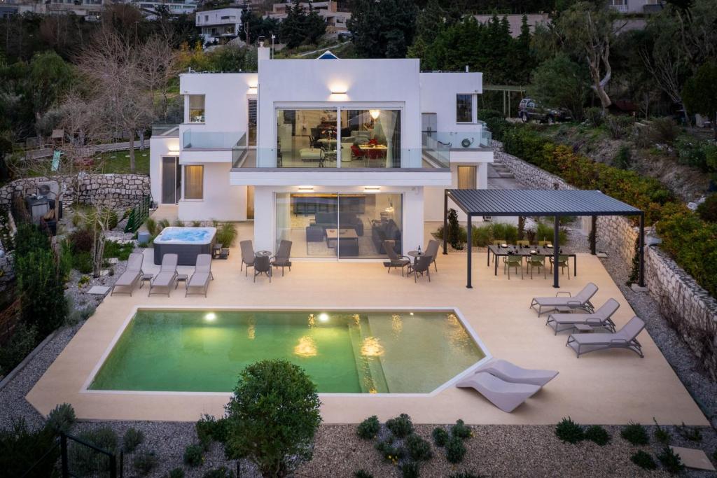 an aerial view of a house with a swimming pool at Vista by Del Sol Villa in Rhodes Town