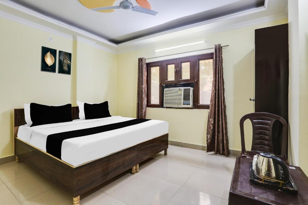a bedroom with a bed and a window at Hotel O Dwarka Metro in New Delhi