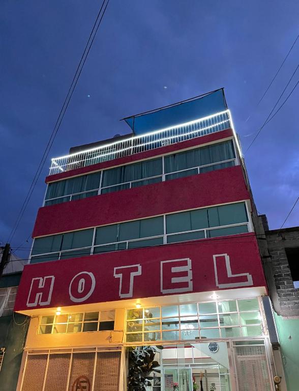 a tall red building with the word otec on it at Camino de la Plata Hotel in Fresnillo de González Echeverría