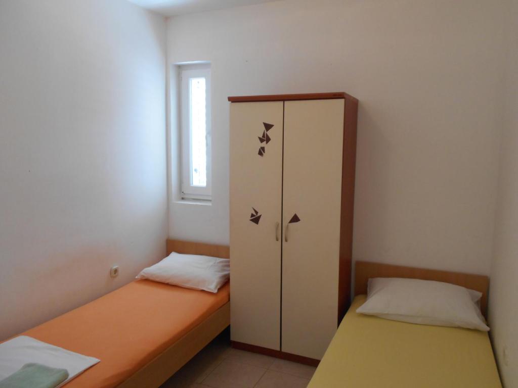 Postel nebo postele na pokoji v ubytování Apartments Dunja Hvar