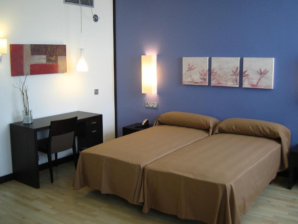 Postel nebo postele na pokoji v ubytování Hotel Puerta de Ocaña