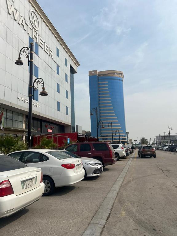 a row of cars parked in front of a building at Hayat Watheer for serviced Apartment in Dammam