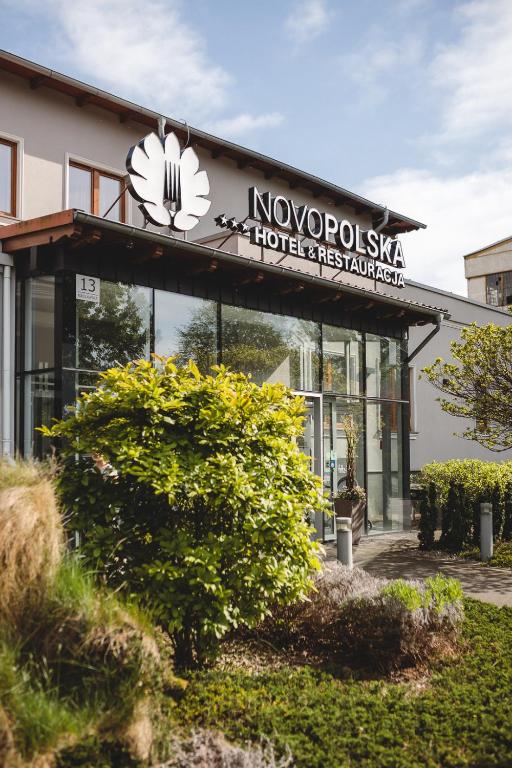a building with a sign on the front of it at Novopolska - Hotel i Restauracja in Kościan