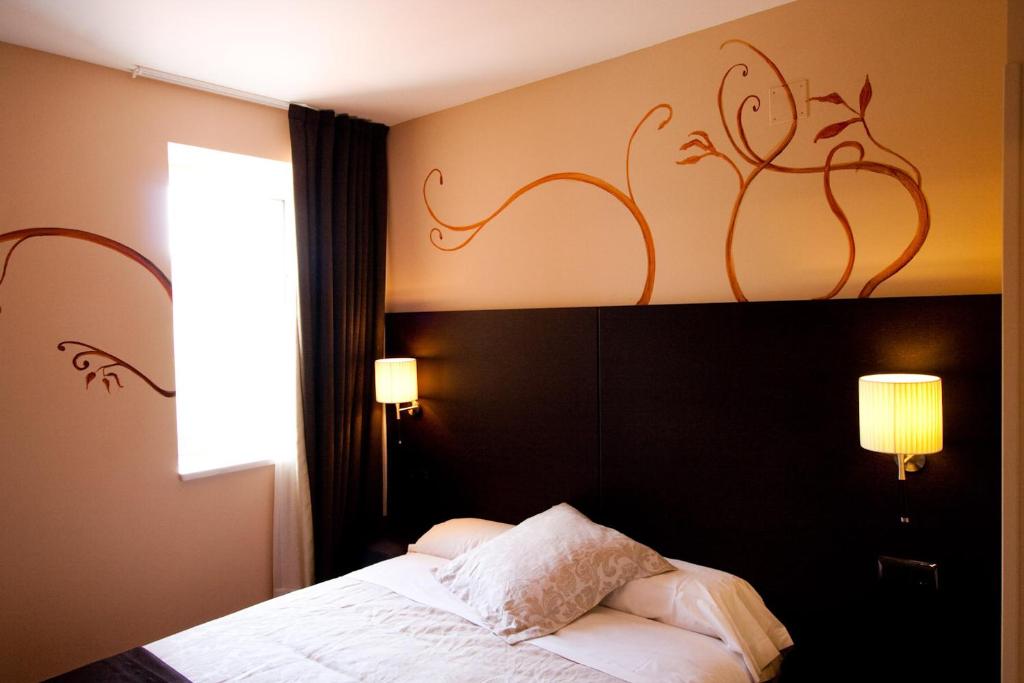 Postel nebo postele na pokoji v ubytování Hotel Restaurante Puente Romano