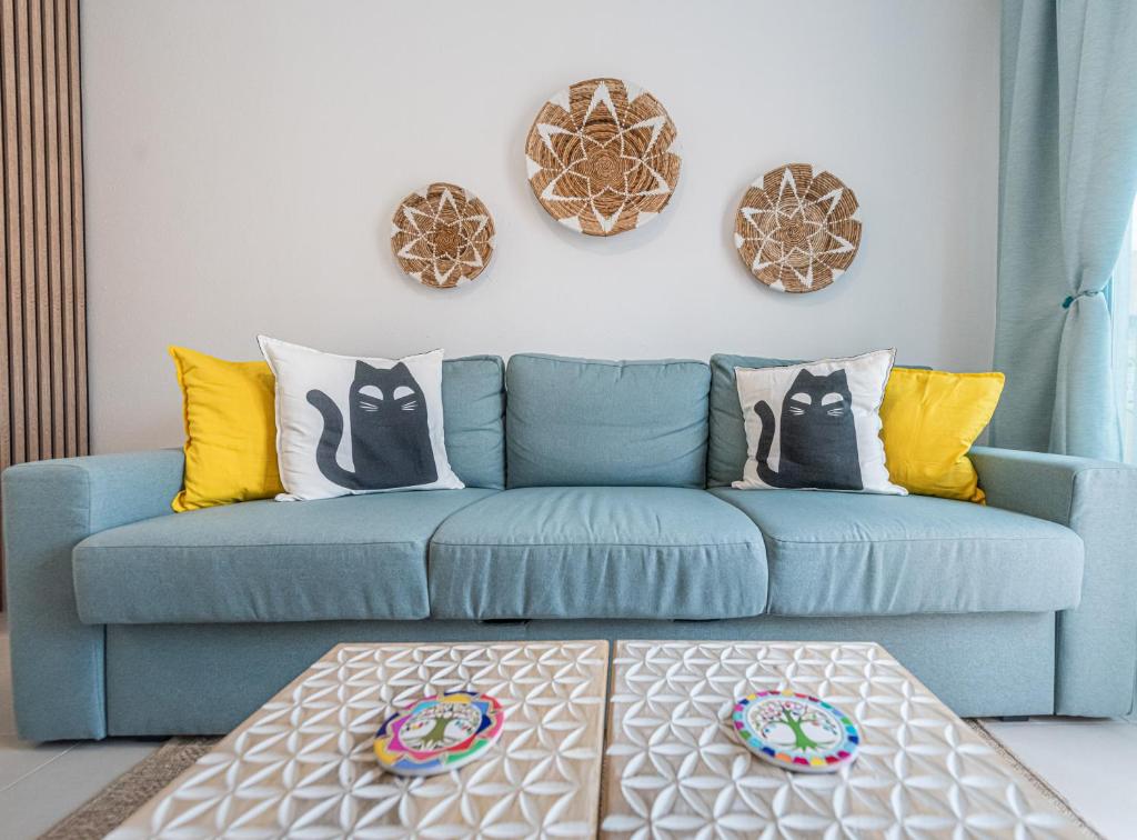 a blue couch in a living room with colorful pillows at Oasis in Costa Calma