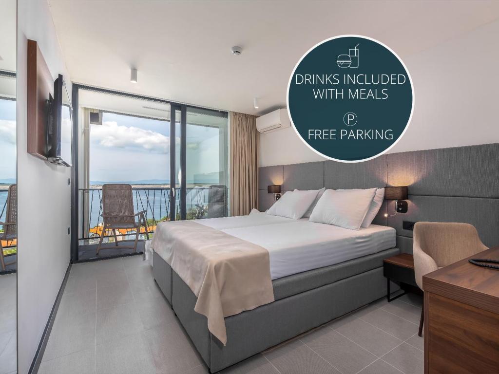 a hotel room with a bed and a balcony at Paviljoni Omorika in Crikvenica