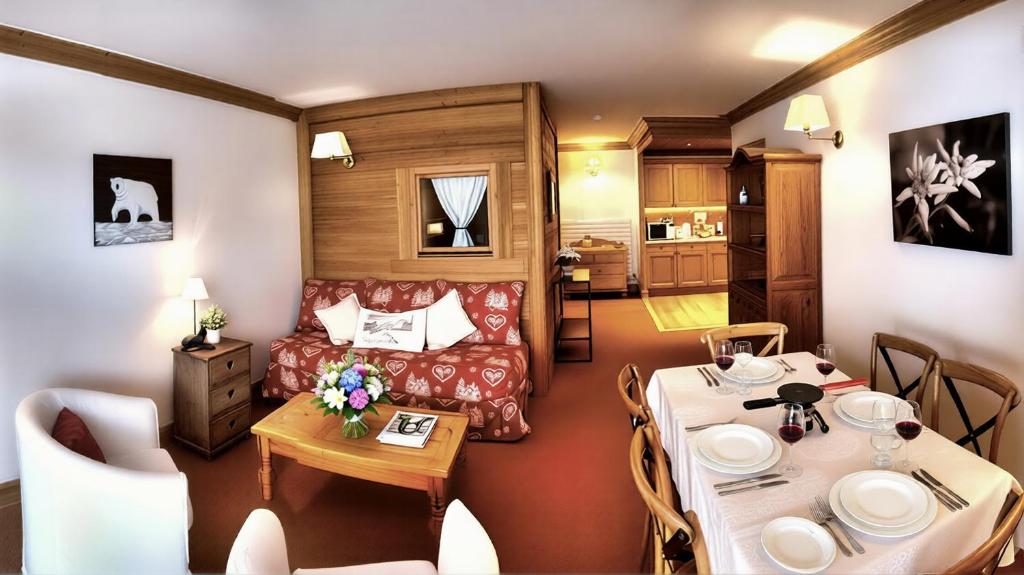 a living room with a couch and a table at Chalet Les Alpes in Val-d'Isère