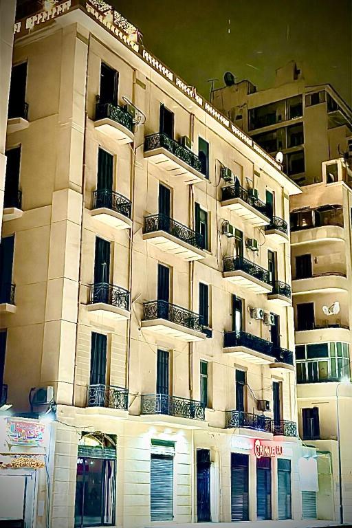 a tall building with balconies on the side of it at Heritage Cairo Hotel Taalat Harb in Cairo