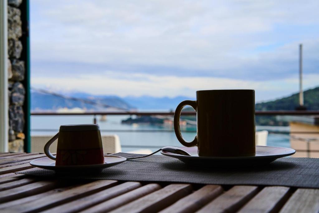 two cups of coffee sitting on a wooden table at Infinity Blue in Portovenere
