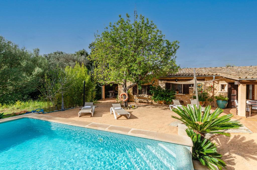 a swimming pool in a yard with a house at YourHouse Padri de Inca in Inca