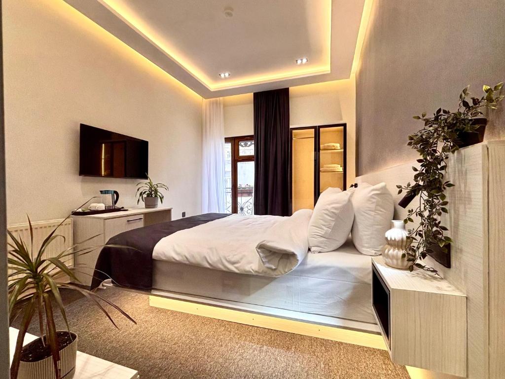a bedroom with a large bed and a window at JM Central Boutique Hotel in Baku