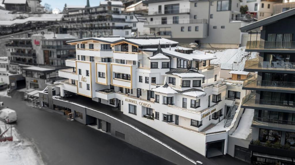 a group of buildings with snow on their roofs at Appartements Aurikel Corso in Ischgl
