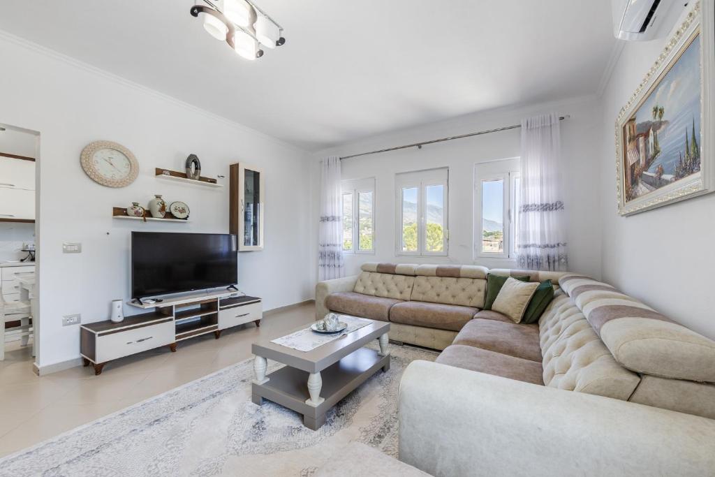 a living room with a couch and a tv at Castle Serenity Home 3BR with Free Parking by PikHost in Gjirokastër