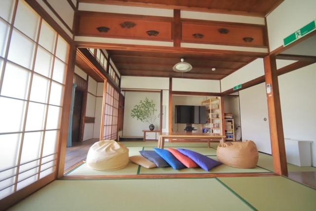 a room with some pillows on the floor at 民泊 Knock Knock in Habikino