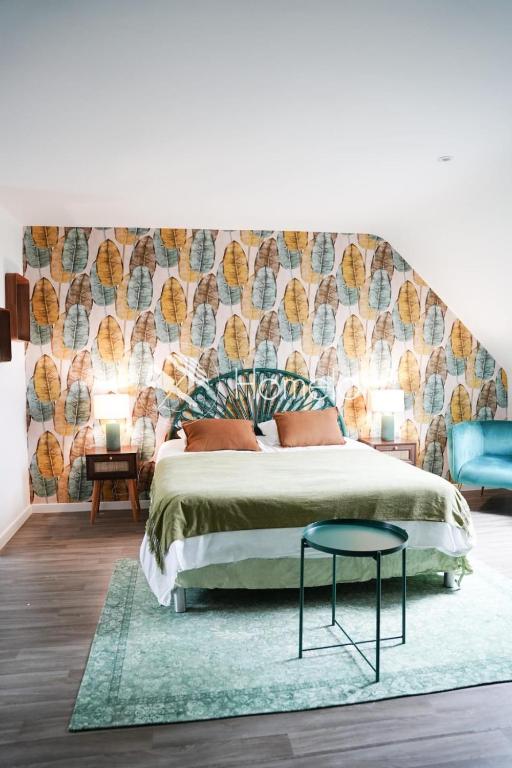 a bedroom with a bed with a large headboard at Jungle Room - Studio avec spa privé in Quéven